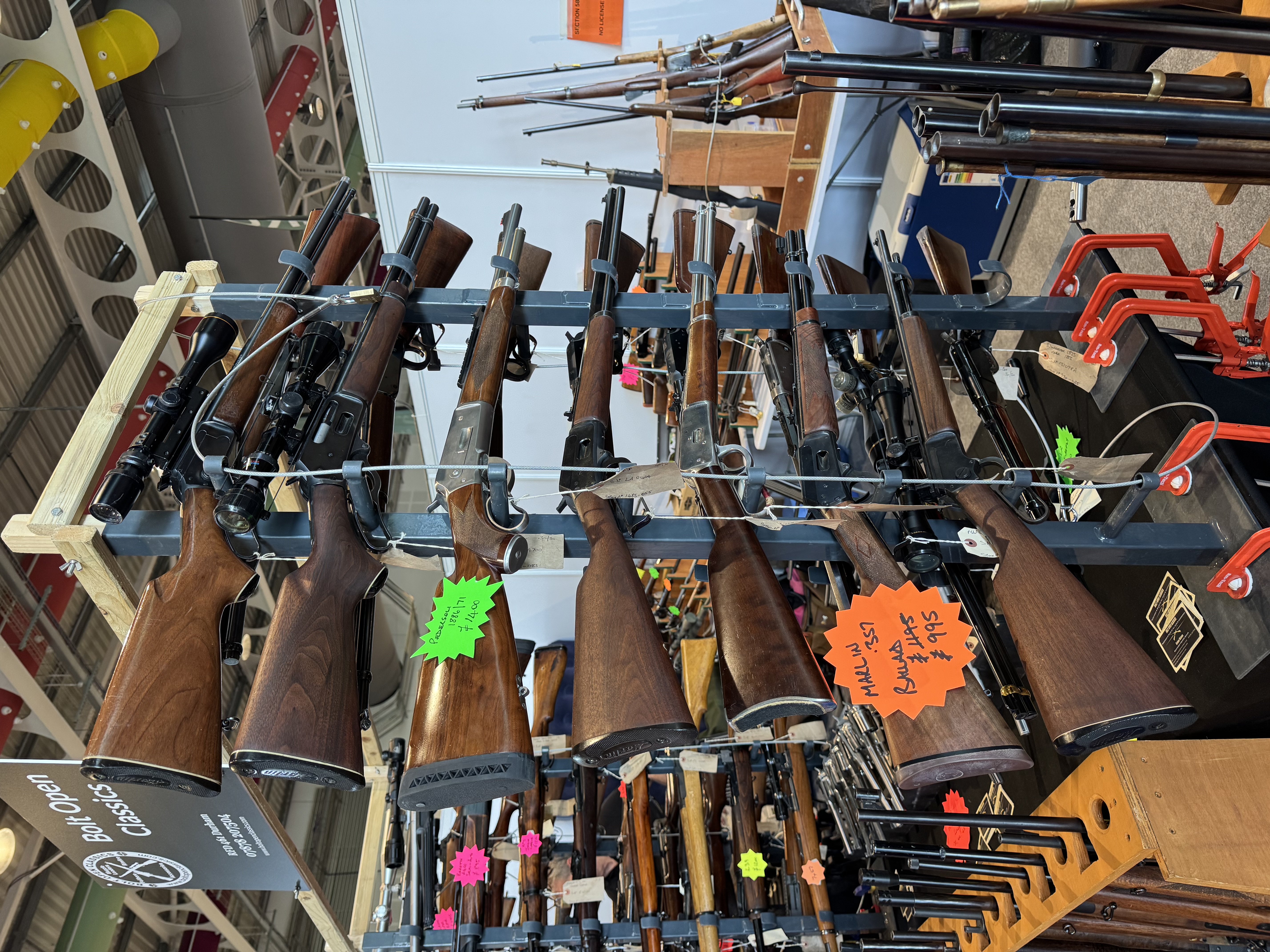 Lever-action rifles displayed at a real indoor gun show
